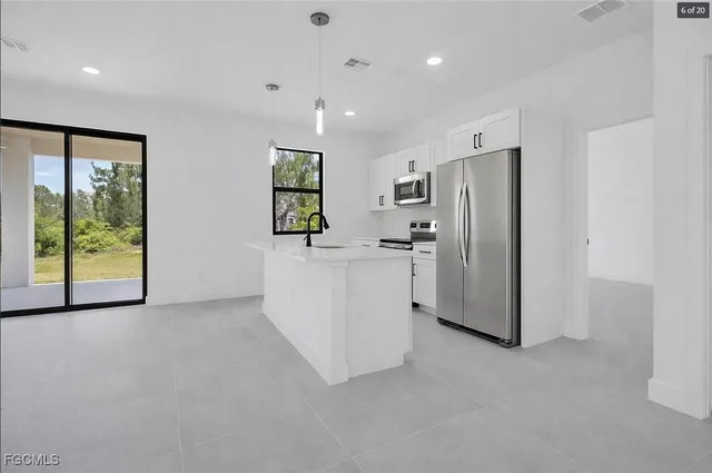 a view of kitchen with refrigerator and window