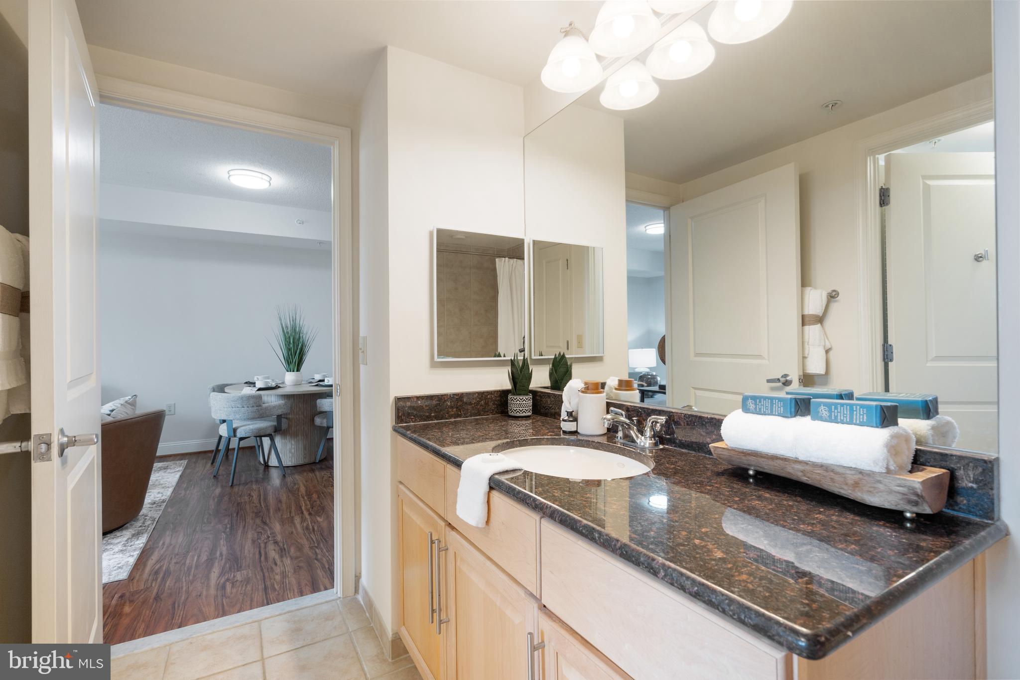11760 Sunrise Valley Drive, Unit 209 Reston, VA 20191 - Photo 9 of 23 a view of a kitchen island dining table and chairs