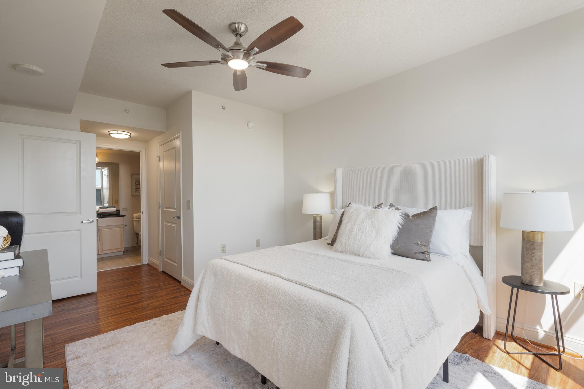 11760 Sunrise Valley Drive, Unit 209 Reston, VA 20191 - Photo 11 of 23 a bedroom with a bed and a walk in closet