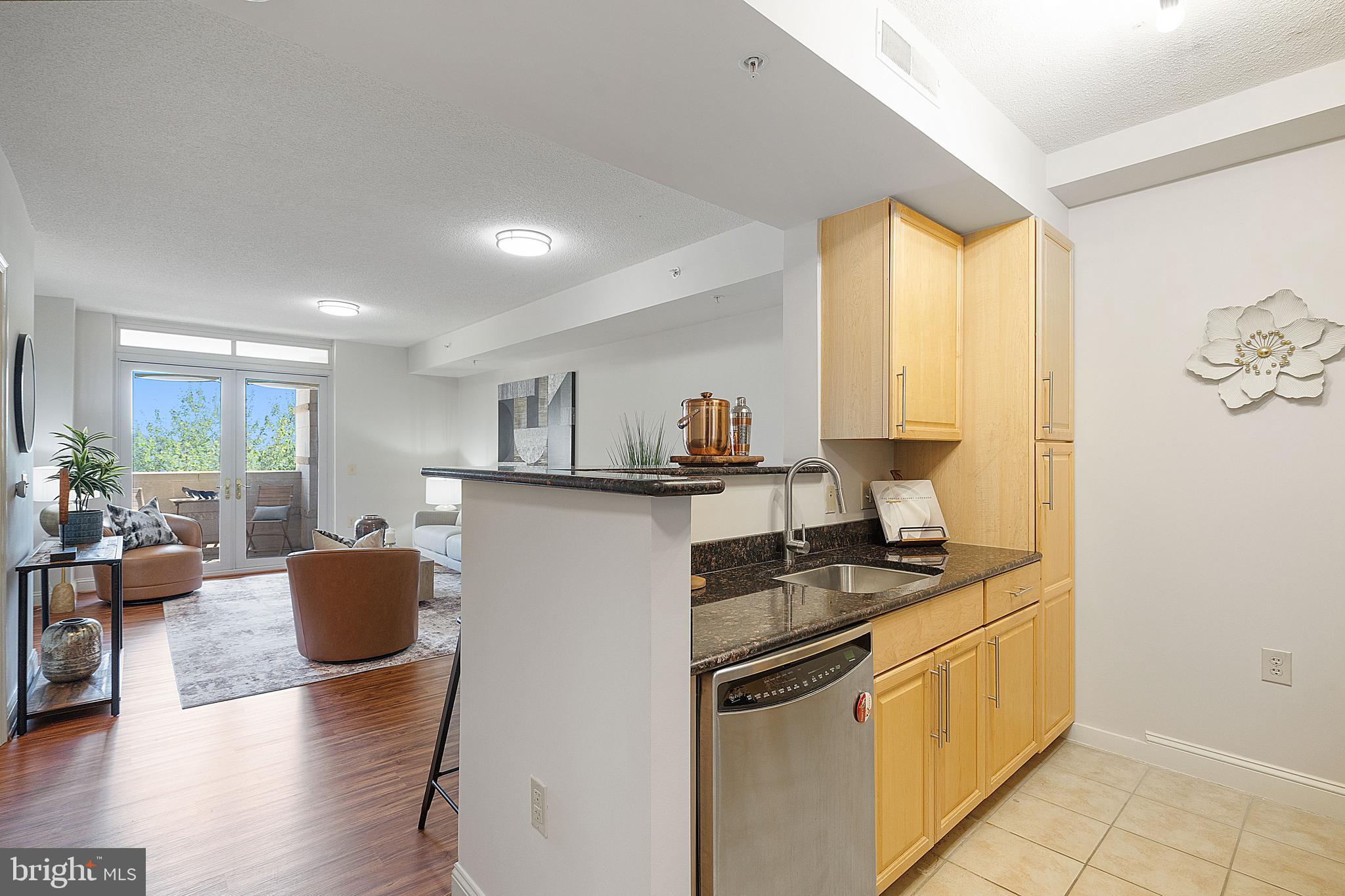 11760 Sunrise Valley Drive, Unit 209 Reston, VA 20191 - Photo 21 of 23 a kitchen with stainless steel appliances granite countertop a stove a sink and a refrigerator
