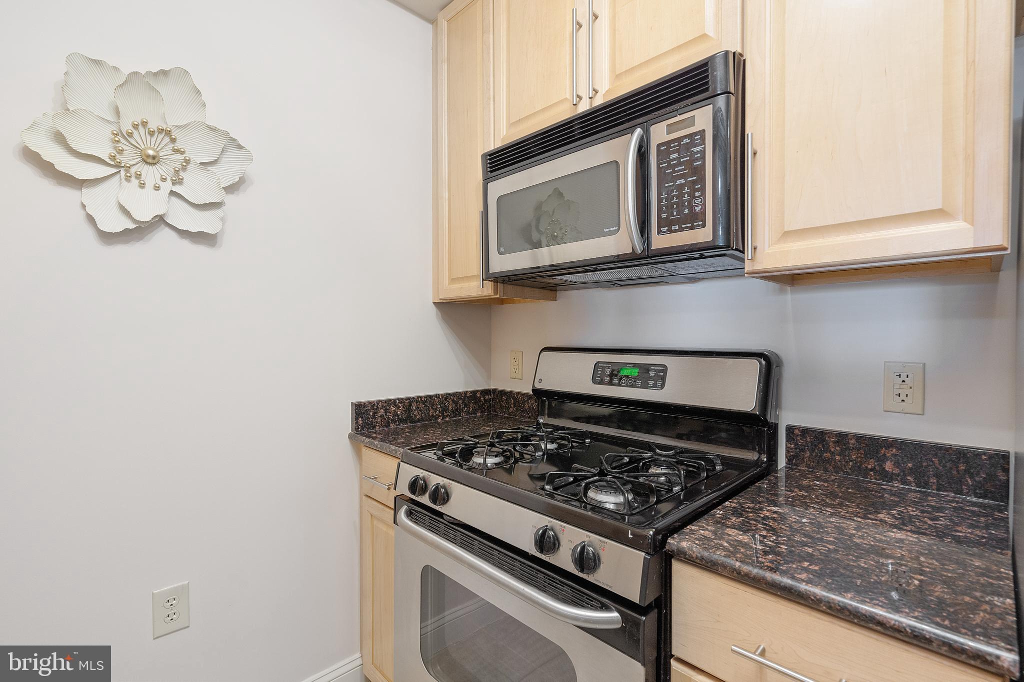 11760 Sunrise Valley Drive, Unit 209 Reston, VA 20191 - Photo 3 of 23 a kitchen with a stove and a microwave