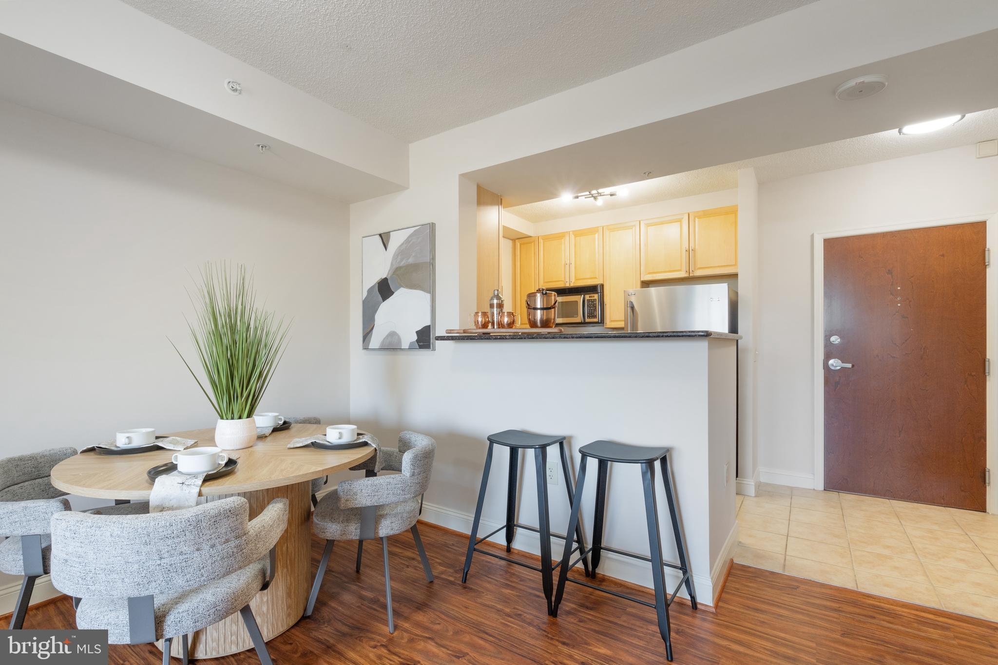 11760 Sunrise Valley Drive, Unit 209 Reston, VA 20191 - Photo 4 of 23 a view of a dining room with furniture and wooden floor