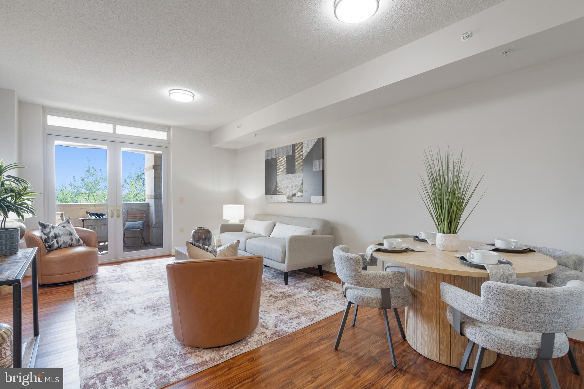 11760 Sunrise Valley Drive, Unit 209 Reston, VA 20191 - Photo 5 of 23 a living room with furniture and a large window
