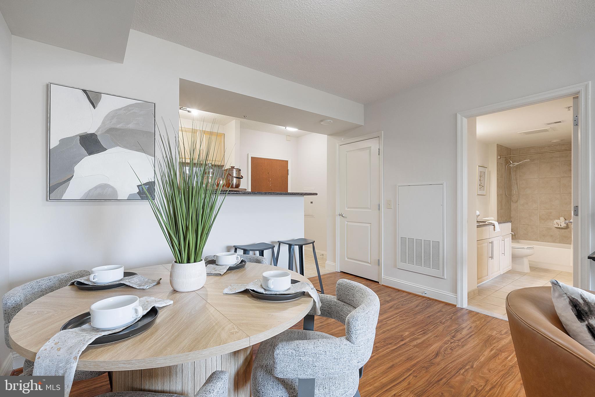 11760 Sunrise Valley Drive, Unit 209 Reston, VA 20191 - Photo 22 of 23 a living room with furniture potted plant and a table