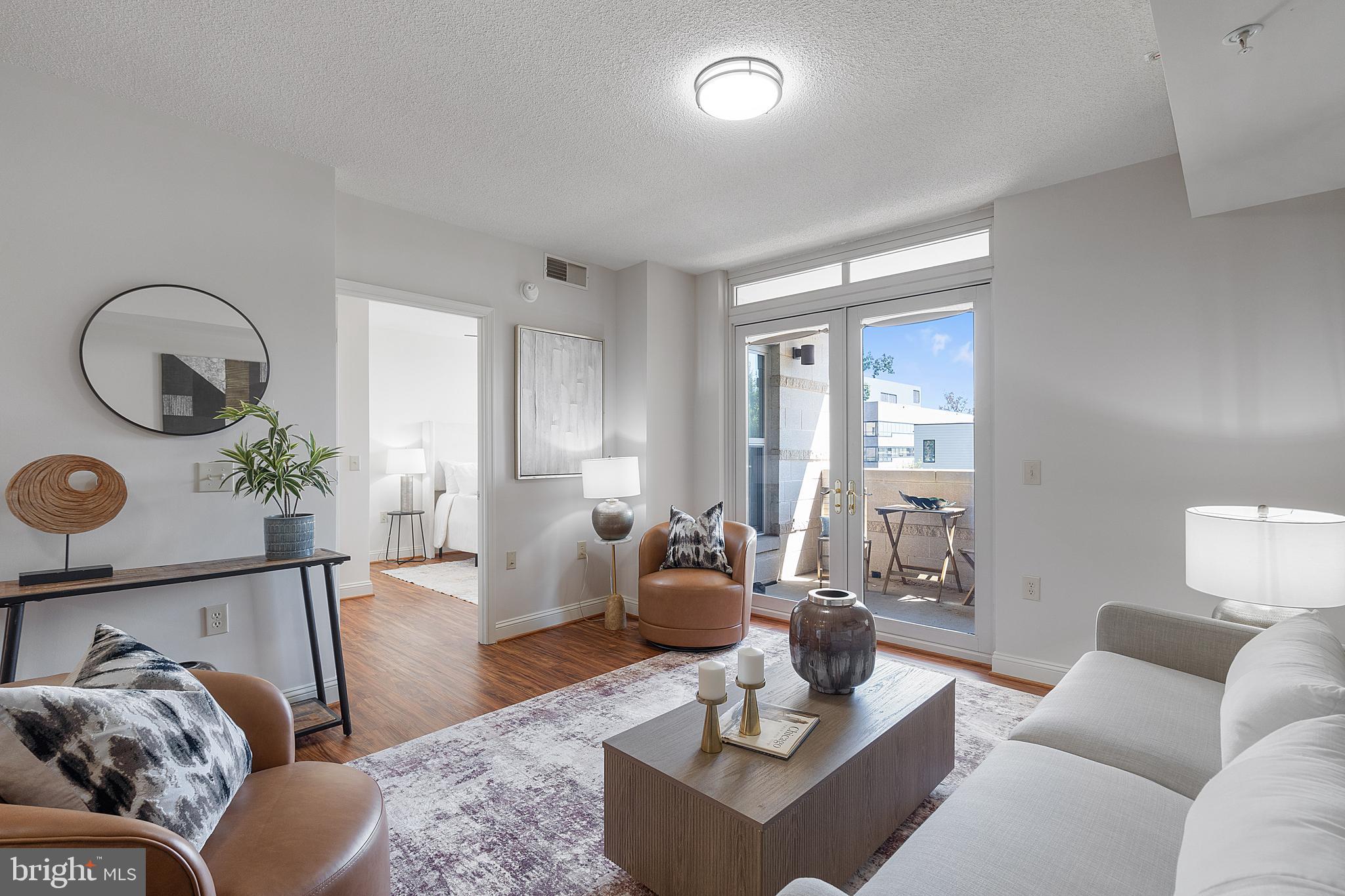 11760 Sunrise Valley Drive, Unit 209 Reston, VA 20191 - Photo 6 of 23 a living room with furniture and wooden floor