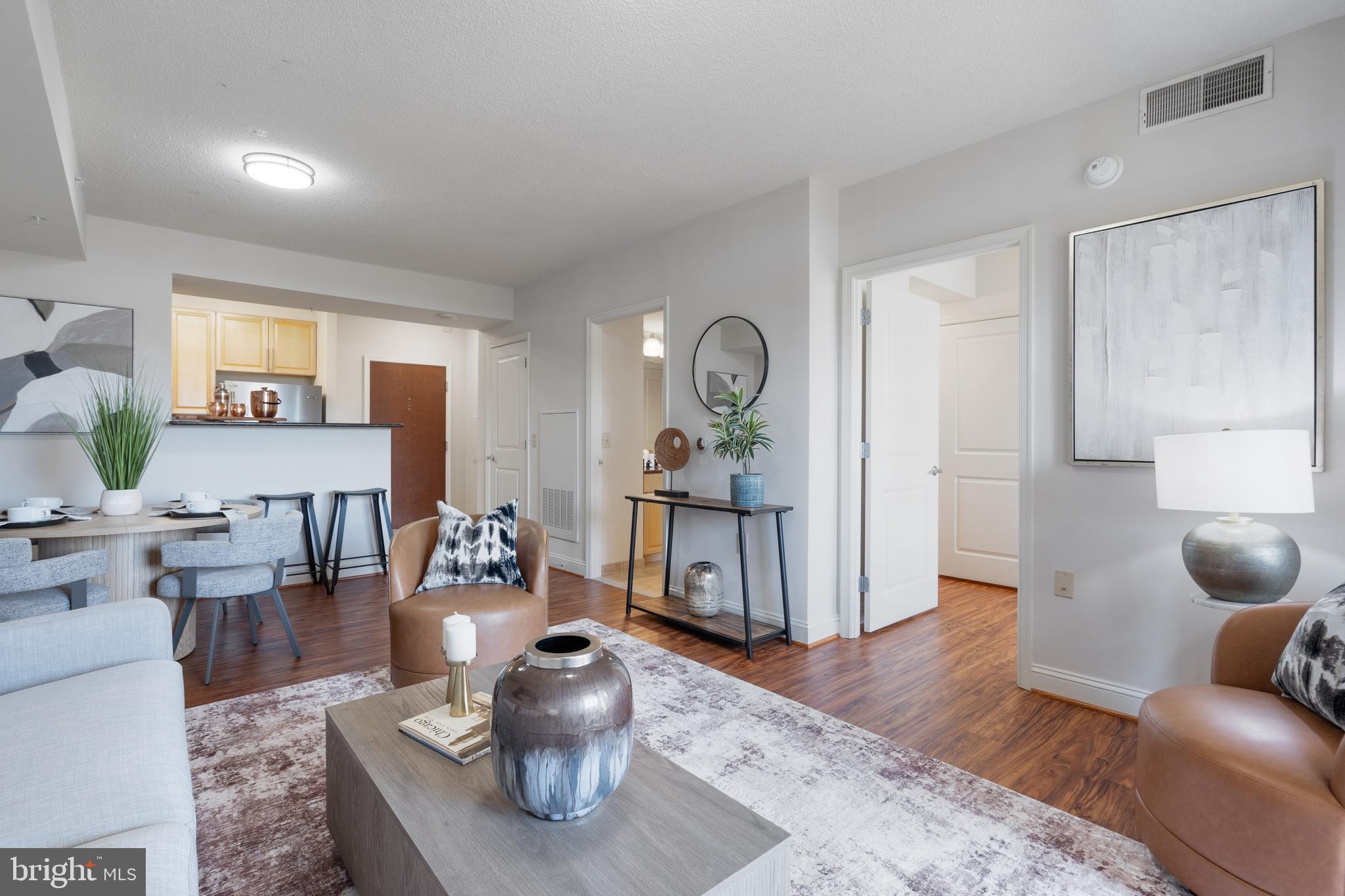 11760 Sunrise Valley Drive, Unit 209 Reston, VA 20191 - Photo 7 of 23 a living room with furniture and wooden floor