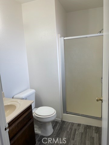 22276 Minnetonka Road Apple Valley, CA 92308 - Photo 7 of 11 a white toilet sitting next to a bathroom sink
