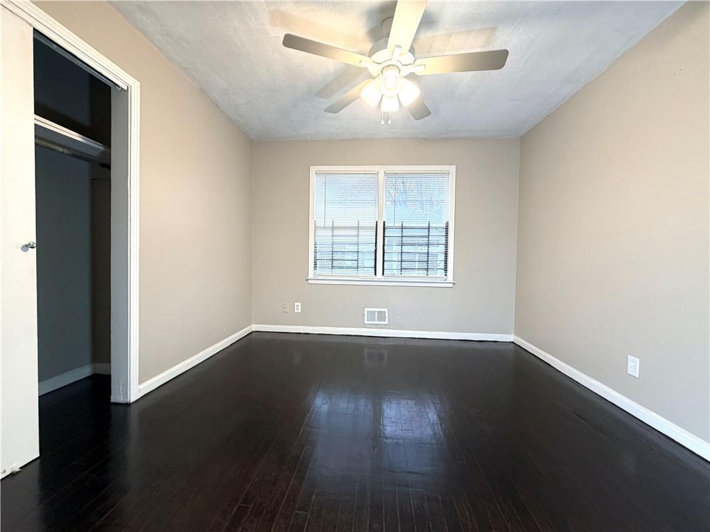 2397 Tilson Road Decatur, GA 30032 - Photo 12 of 22 a view of an empty room with wooden floor and a window
