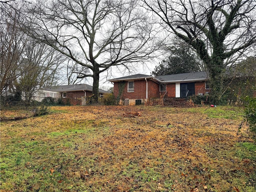 2397 Tilson Road Decatur, GA 30032 - Photo 18 of 22 a front view of a house with a yard and trees