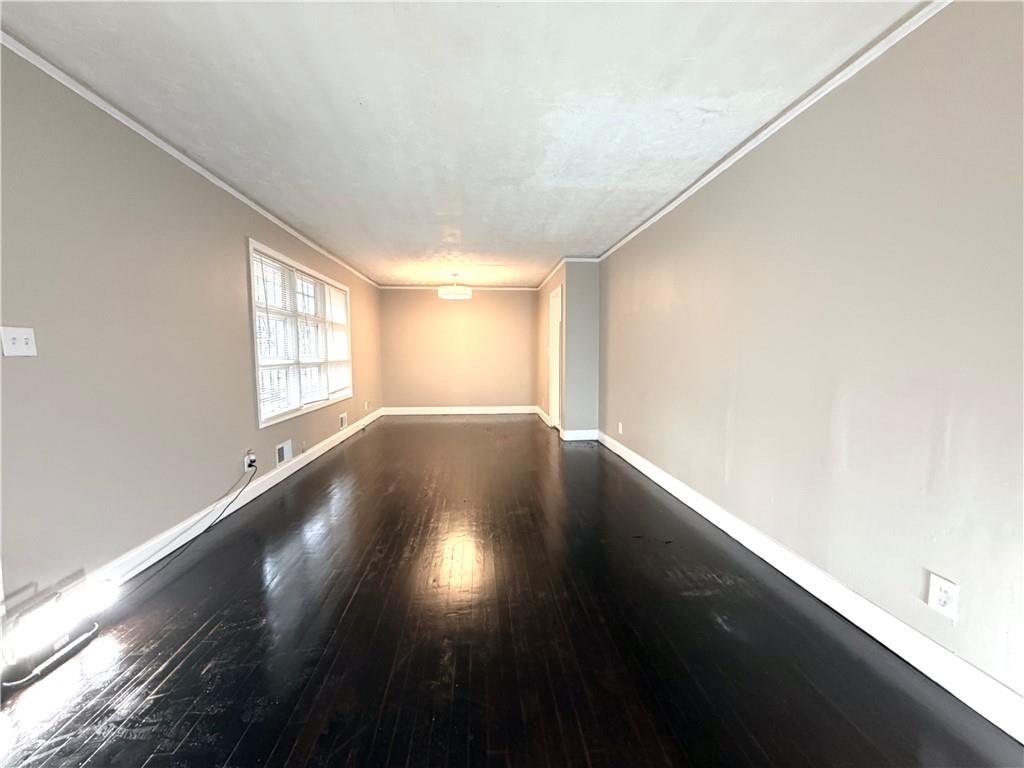2397 Tilson Road Decatur, GA 30032 - Photo 4 of 22 an empty room with wooden floor and windows