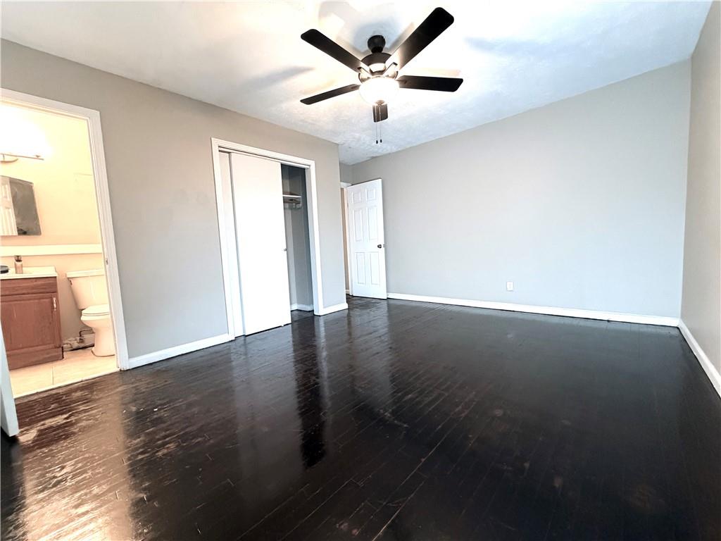 2397 Tilson Road Decatur, GA 30032 - Photo 9 of 22 an empty room with wooden floor and windows