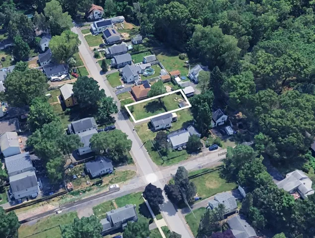 an aerial view of a house with a yard