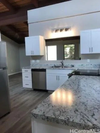 a kitchen with a sink cabinets and a wooden floor