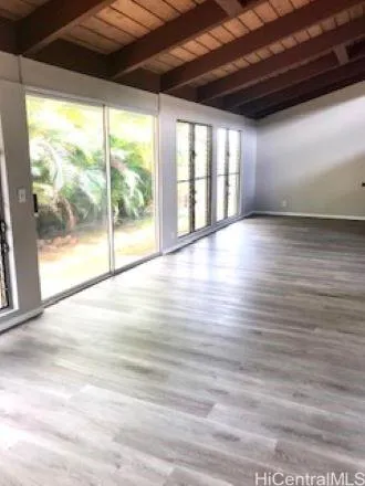 a view of room with wooden floor and glass door
