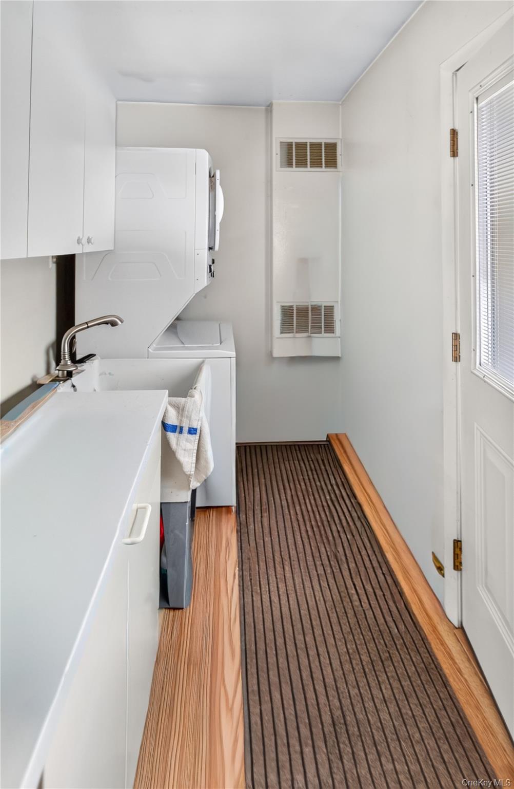 261 Hallock Road Stony Brook, NY 11790 - Photo 11 of 13 a view of hallway with a large window and wooden floor