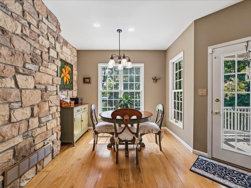 1168 Mt Pleasant Road Bangor, PA 18013 - Photo 38 of 100 Natural stone accent walls flank a sunny dining area with rich hardwood flooring.