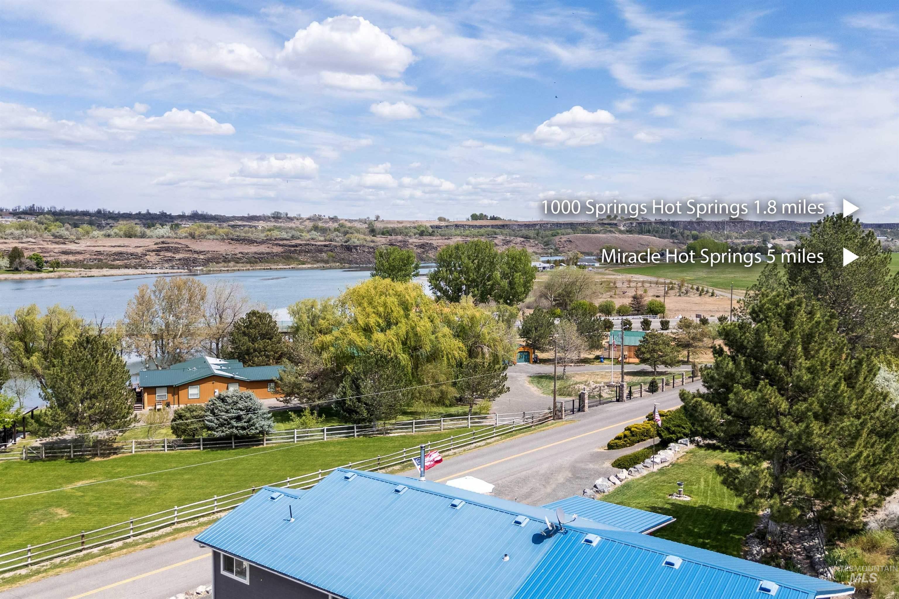 11 Bell Rapids Road Hagerman, ID 83332 - Photo 13 of 40 Aerial perspective showcasing a property with a blue metal roof and extensive green lawn