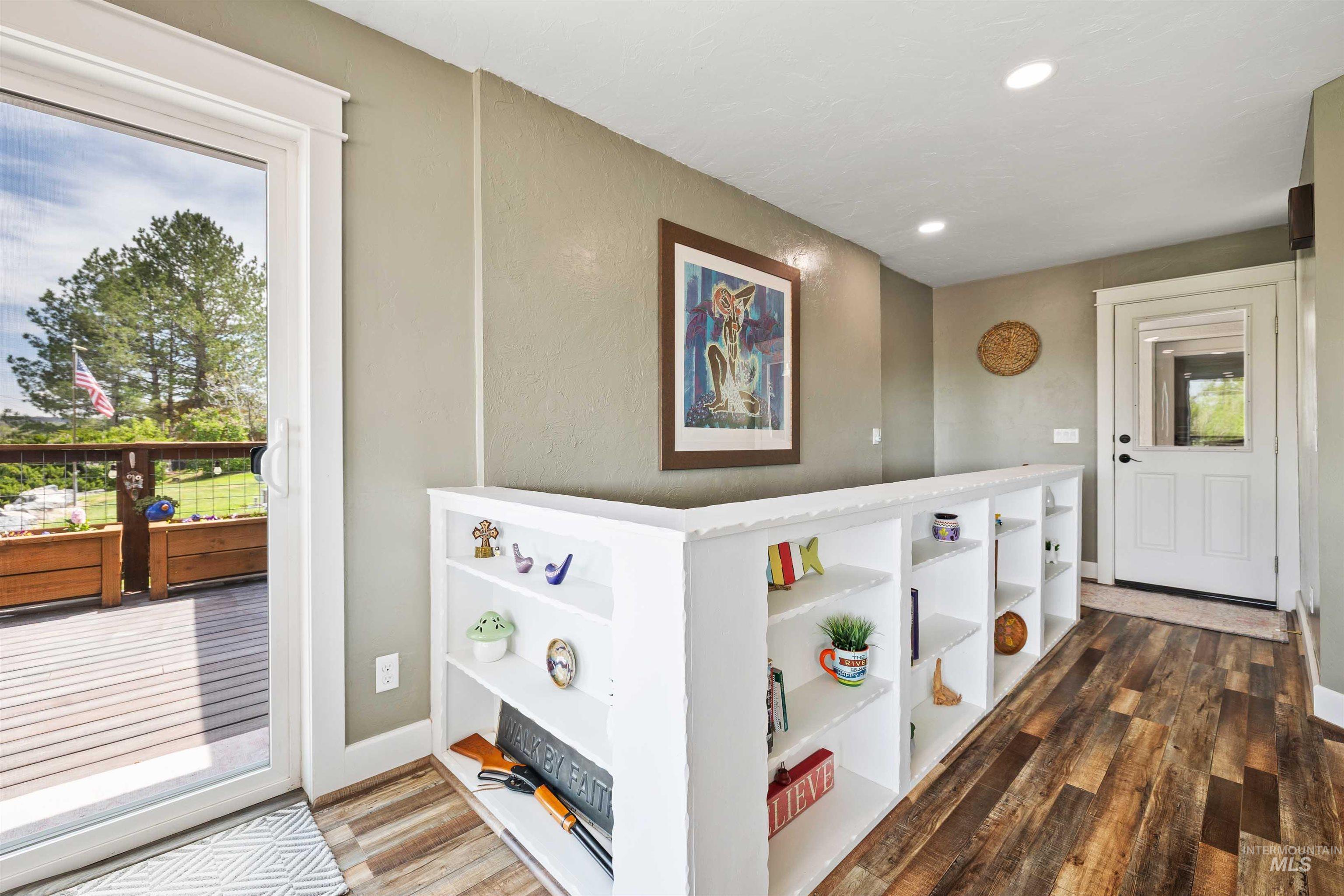 11 Bell Rapids Road Hagerman, ID 83332 - Photo 14 of 40 Spacious interior featuring wood-finish flooring, built-in shelving, recessed lighting, and a white sliding glass door opening to a deck
