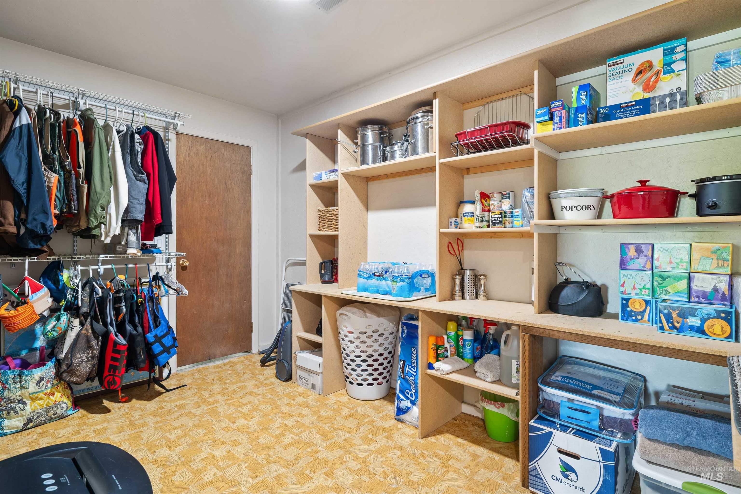 11 Bell Rapids Road Hagerman, ID 83332 - Photo 37 of 40 Dedicated storage room featuring extensive built-in shelving, durable flooring, a full-height solid core door, and a comprehensive wall-mounted clothing rod system