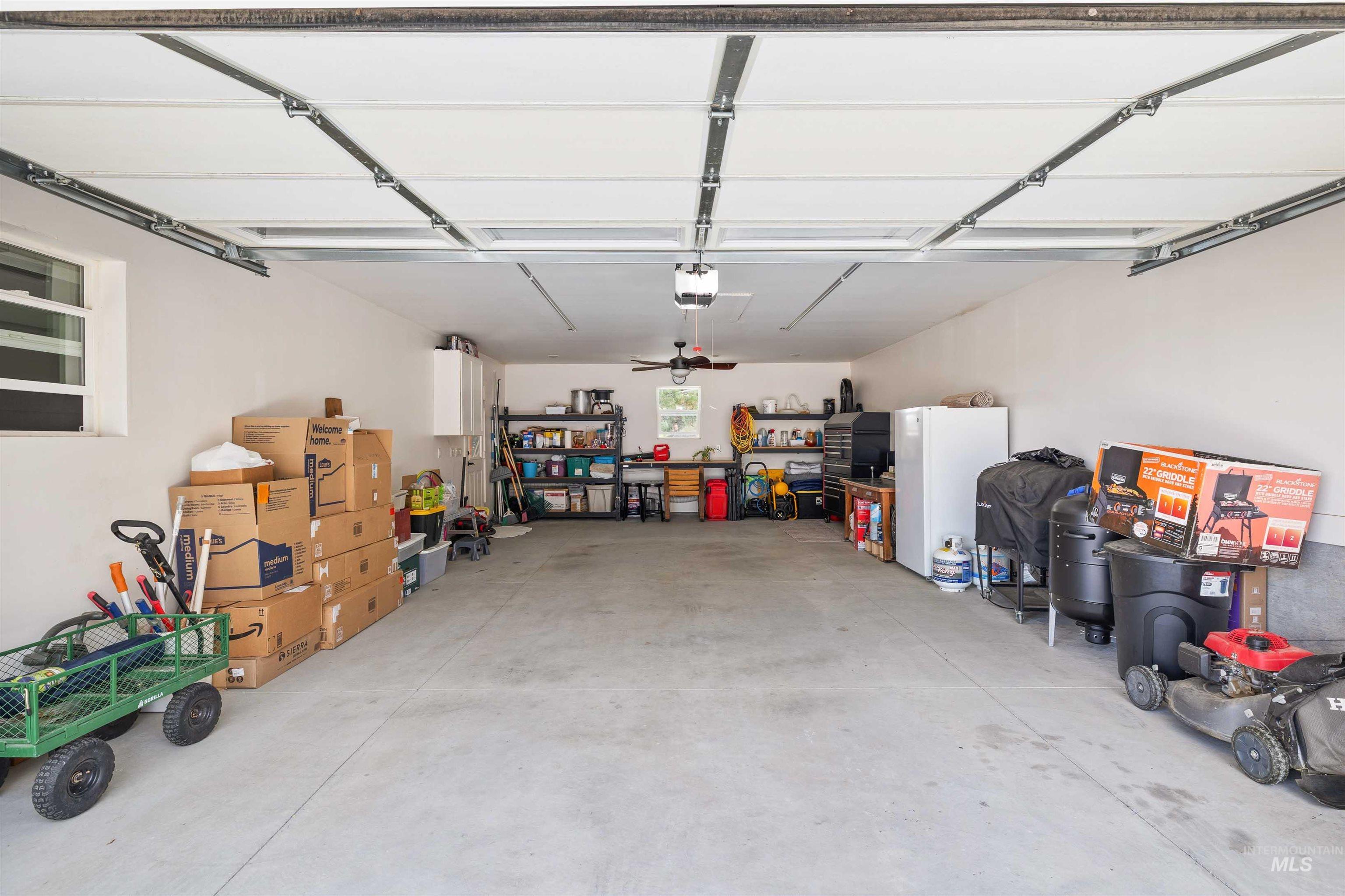 11 Bell Rapids Road Hagerman, ID 83332 - Photo 38 of 40 Spacious garage with an automatic garage door opener, concrete flooring, and a ceiling fan