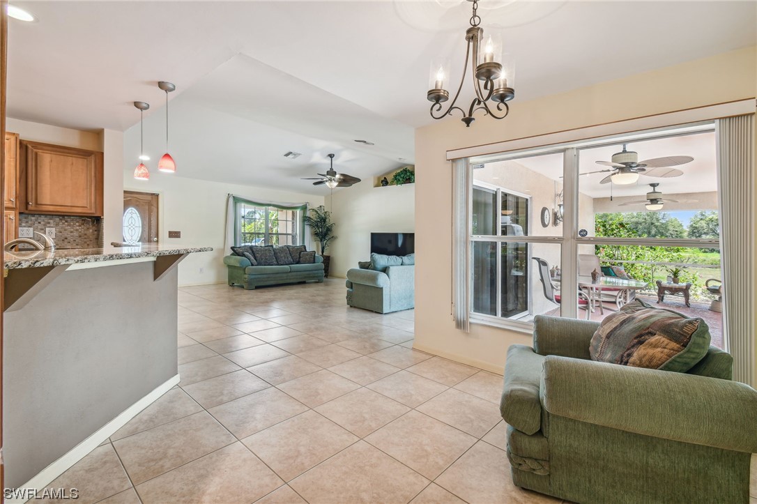 430 Rathburn Street Lehigh Acres, FL 33974 - Photo 11 of 50 a living room with furniture and a chandelier
