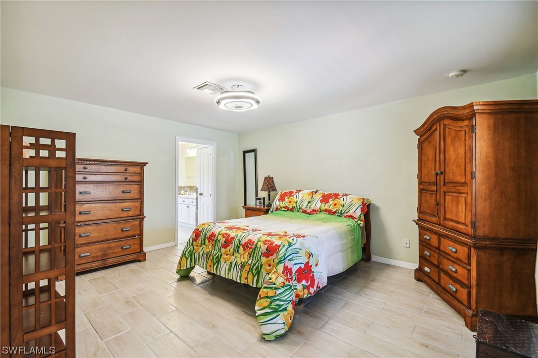 430 Rathburn Street Lehigh Acres, FL 33974 - Photo 26 of 50 a bedroom with a bed and dresser