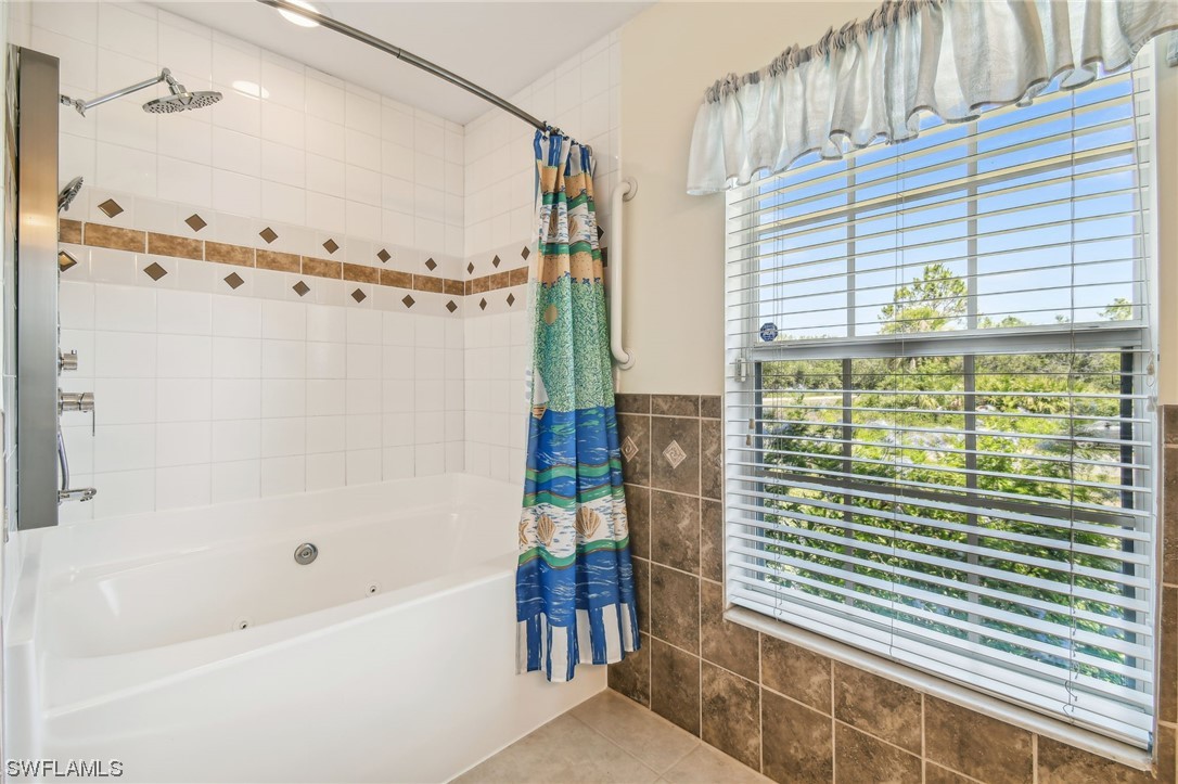 430 Rathburn Street Lehigh Acres, FL 33974 - Photo 31 of 50 a bathroom with a bathtub and a shower