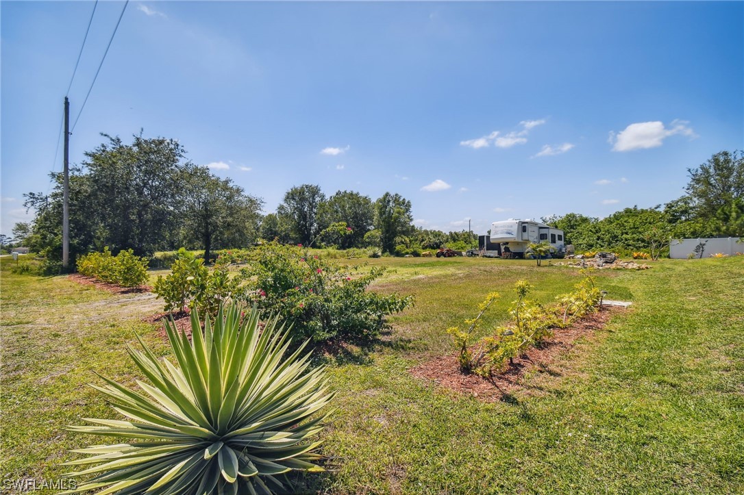 430 Rathburn Street Lehigh Acres, FL 33974 - Photo 42 of 50 a view of a lake with a big yard