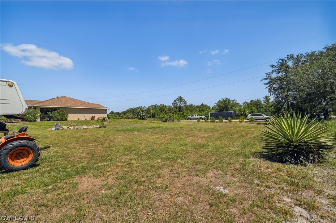 430 Rathburn Street Lehigh Acres, FL 33974 - Photo 44 of 50 a view of a lake with a yard