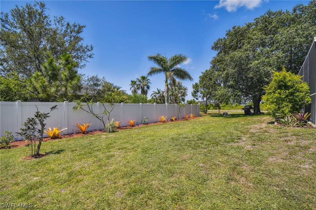 430 Rathburn Street Lehigh Acres, FL 33974 - Photo 47 of 50 a backyard of a house with lots of green space