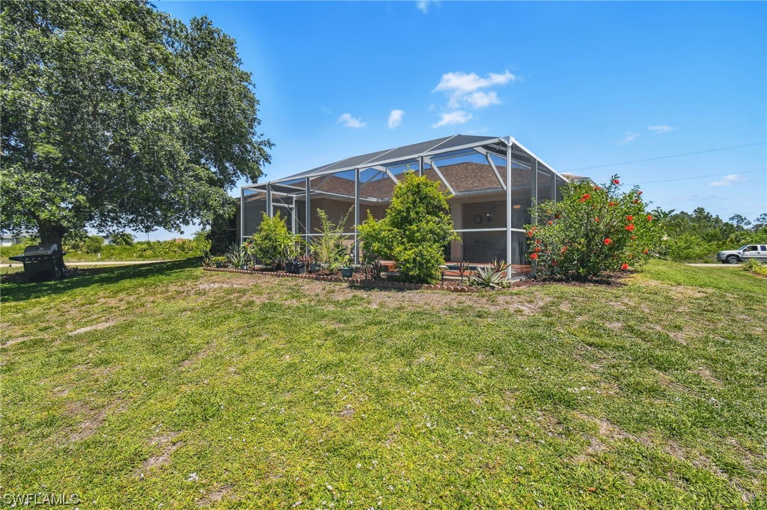 430 Rathburn Street Lehigh Acres, FL 33974 - Photo 48 of 50 a view of a house with backyard and garden