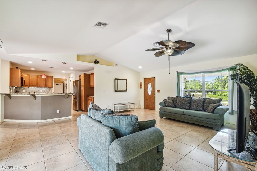 430 Rathburn Street Lehigh Acres, FL 33974 - Photo 6 of 50 a living room with furniture and a large window