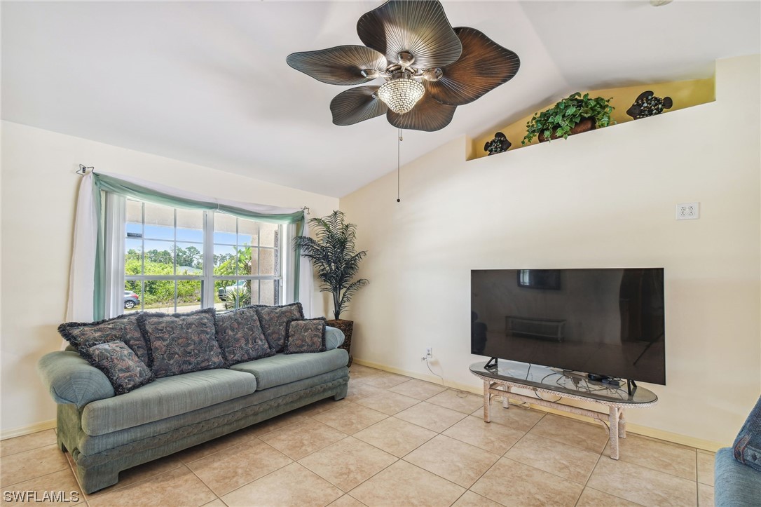 430 Rathburn Street Lehigh Acres, FL 33974 - Photo 7 of 50 a living room with furniture and a flat screen tv