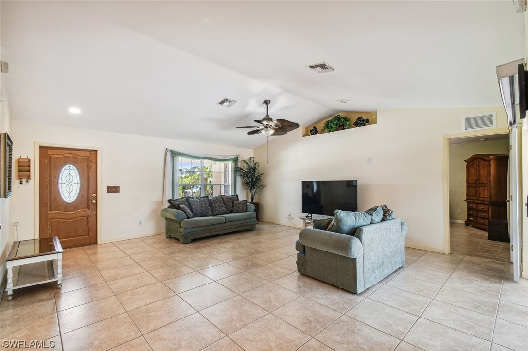 430 Rathburn Street Lehigh Acres, FL 33974 - Photo 8 of 50 a living room with furniture and a flat screen tv