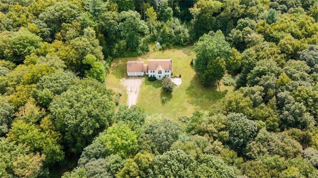 an aerial view of a house with a yard