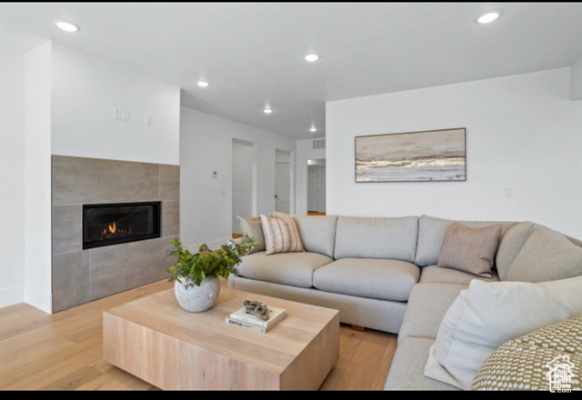 599 North Heritage Street, Unit 6 Mapleton, UT 84664 - Photo 21 of 37 Living room featuring light hardwood / wood-style floors and a tiled fireplace