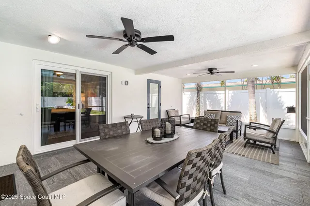 a living room with lots of furniture and a large window
