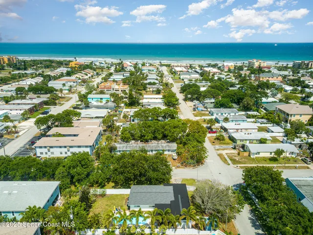 a kitchen with stainless steel appliances a dining table chairs and wooden floor