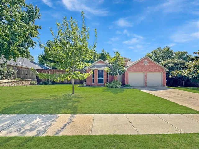 a view of an house with backyard space and garden