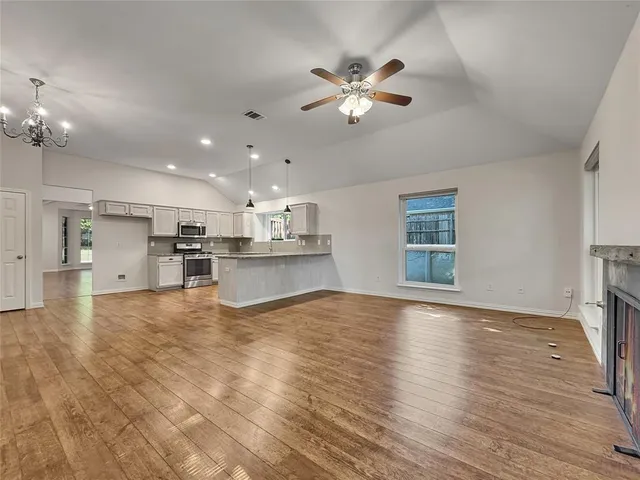 a view of a kitchen with a sink and chandelier