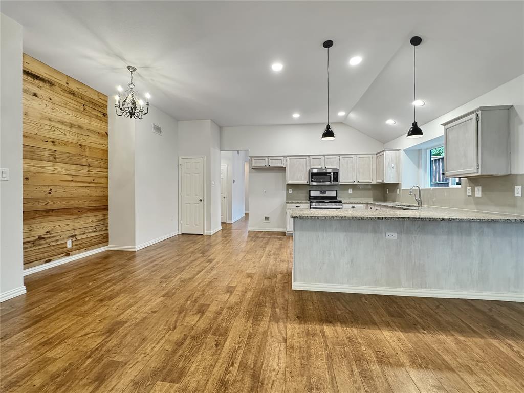 806 Glenwood Court McKinney, TX 75071 - Photo 4 of 29 a large kitchen with stainless steel appliances granite countertop a granite counter tops and a wooden floors