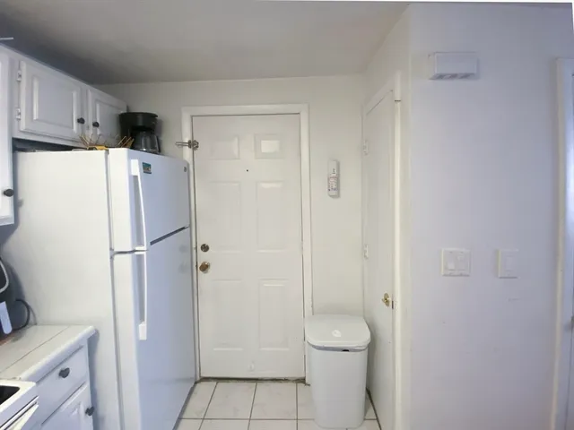 a white refrigerator freezer sitting inside of a kitchen