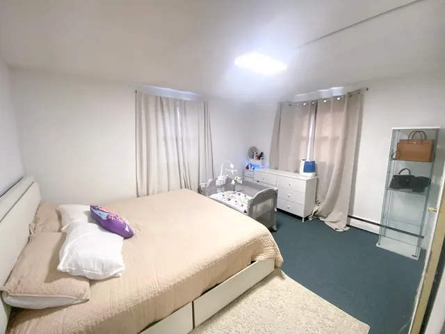 a spacious bedroom with a bed and a couch