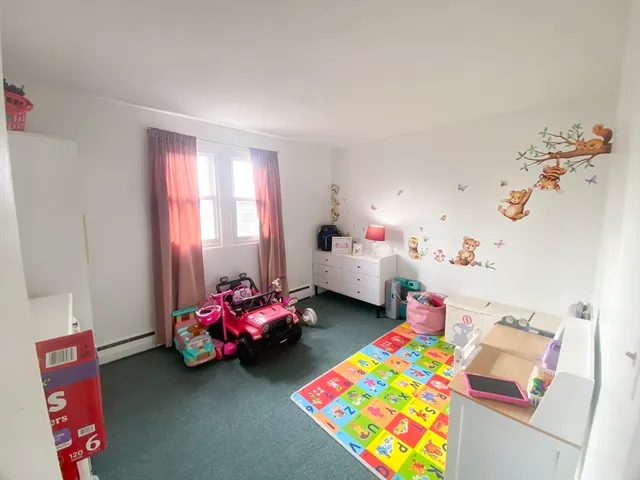 a bedroom with bed and a window