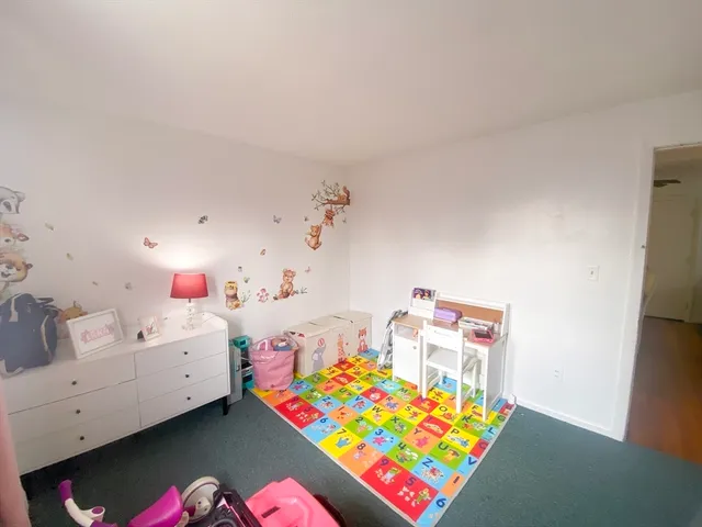 a bedroom with furniture and a baby crib