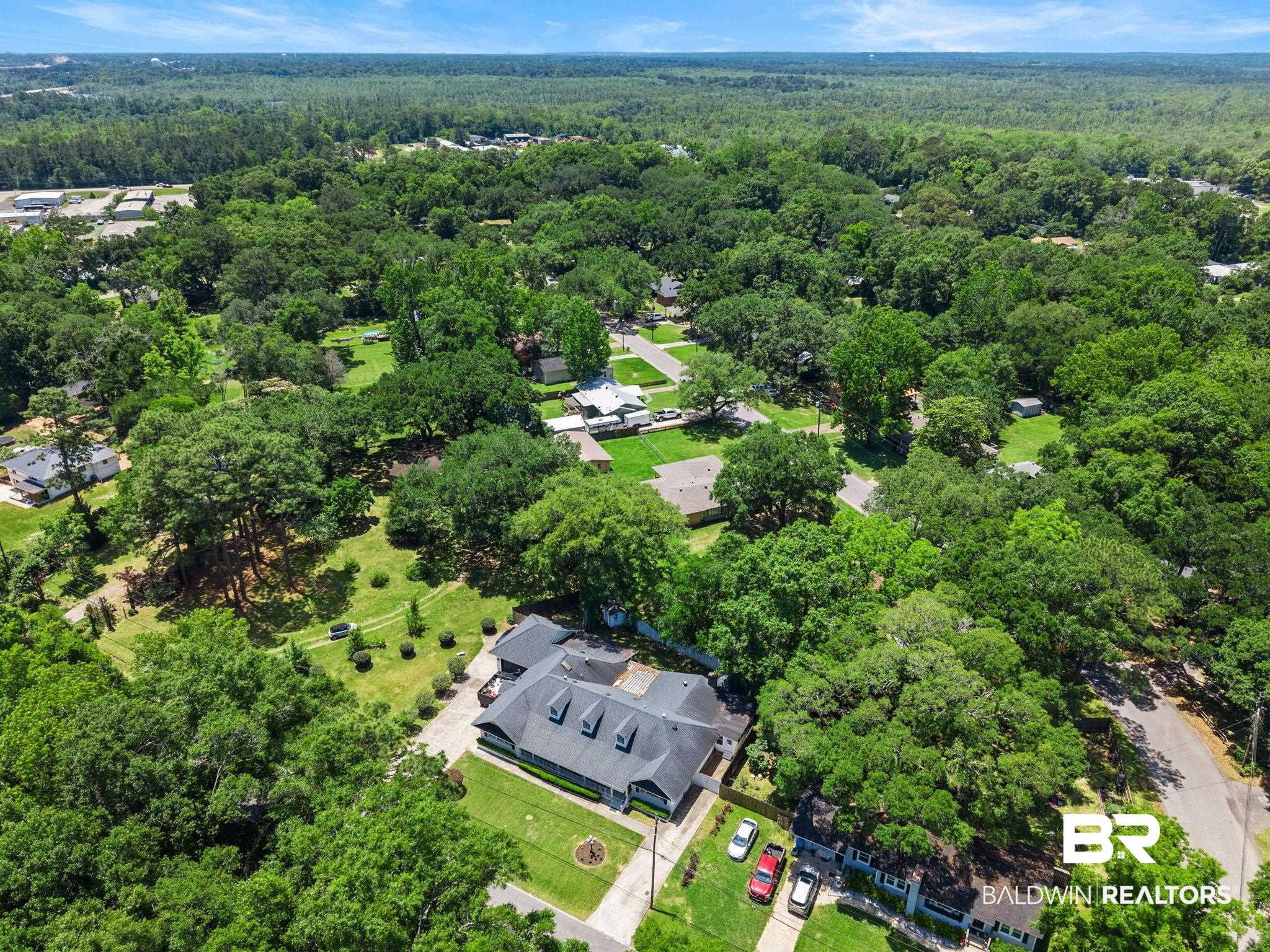 927 Cleveland Road Saraland, AL 36571 - Photo 69 of 80 Expansive property featuring a large residence with a dark shingle roof and multiple dormer windows
