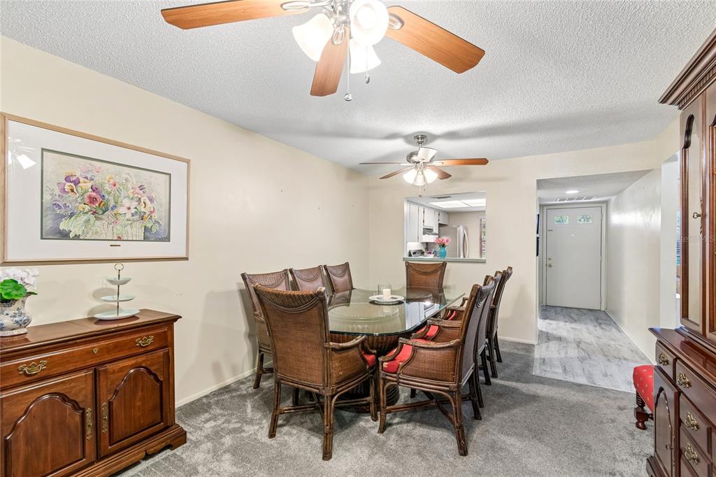 11340 Carriage Hill Drive, Unit 4 Port Richey, FL 34668 - Photo 12 of 36 a view of a dining room with furniture and chandelier