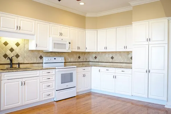 a view of empty room with wooden floor and fireplace