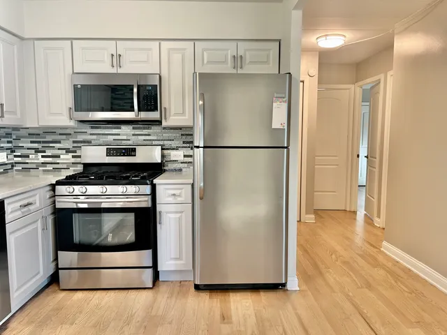 a kitchen with stainless steel appliances a refrigerator stove and microwave