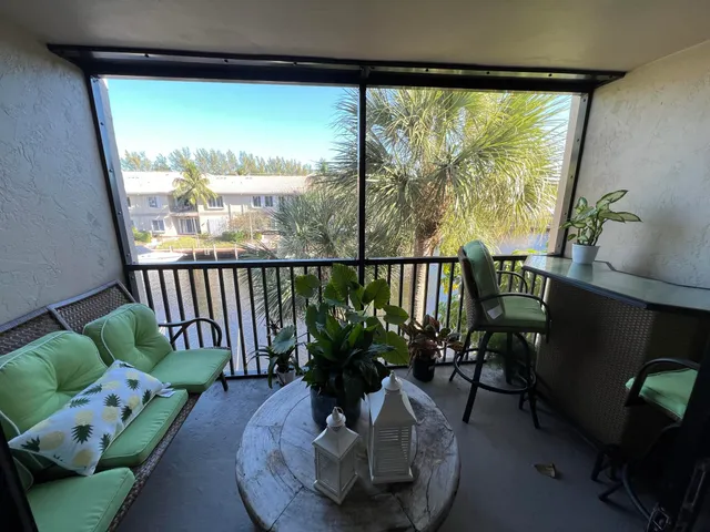 a view of a porch with furniture and a potted plant